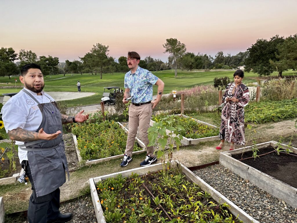 Standing in the chefs garden with Chef Diaz overlooking the golf course.
